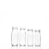 16盎司空的透明玻璃牛奶汁喝塑料盖的瓶